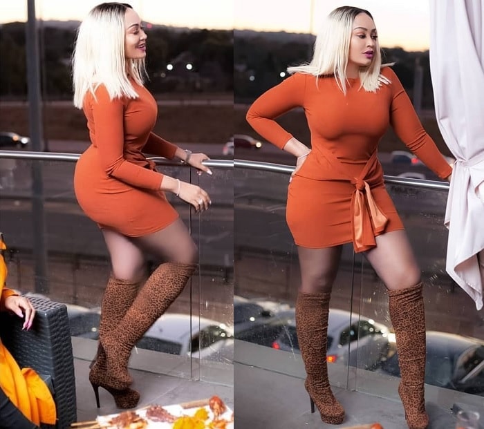 Zari in her body hugging short dress with knee high boots